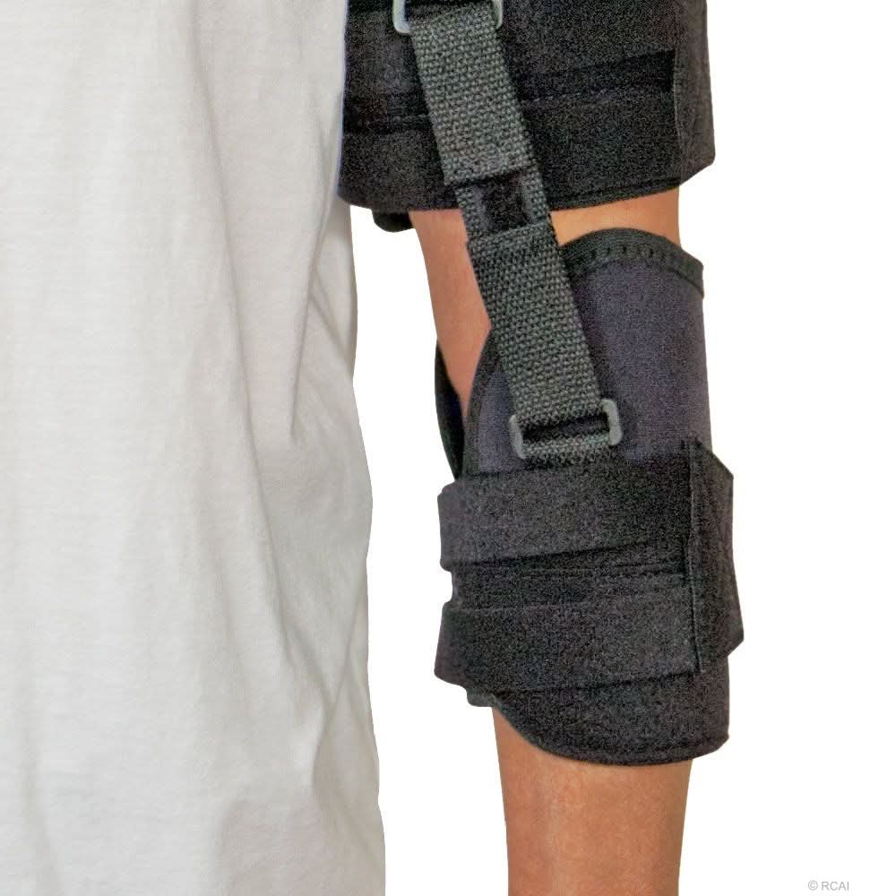 Black neoprene shoulder stabilizer with adjustable straps and buckles on a person's arm, made in the USA, best orthopedic.
