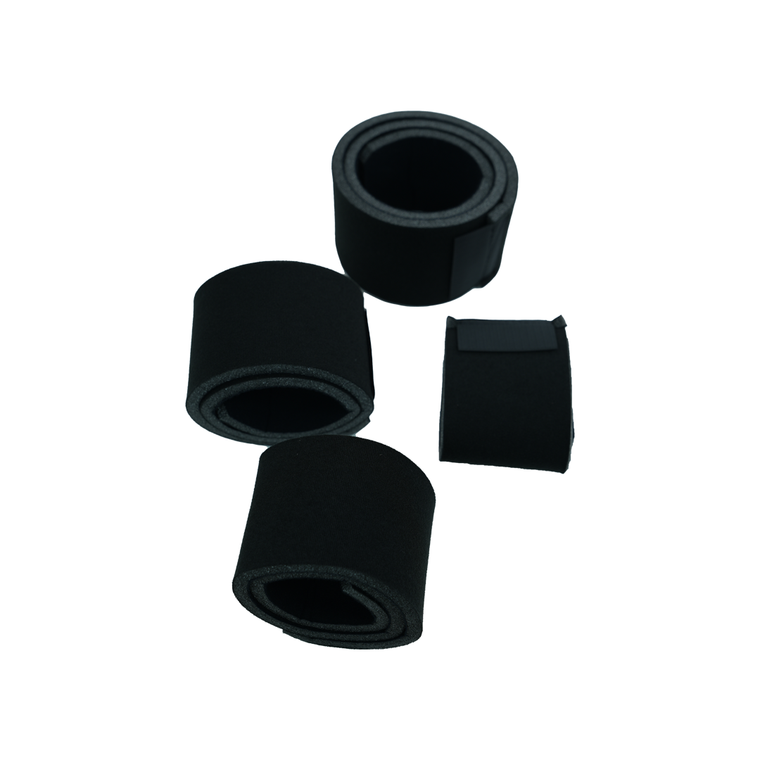 Four black foam-padded straps of varying widths and lengths, designed as knee brace accessories, arranged on a white.